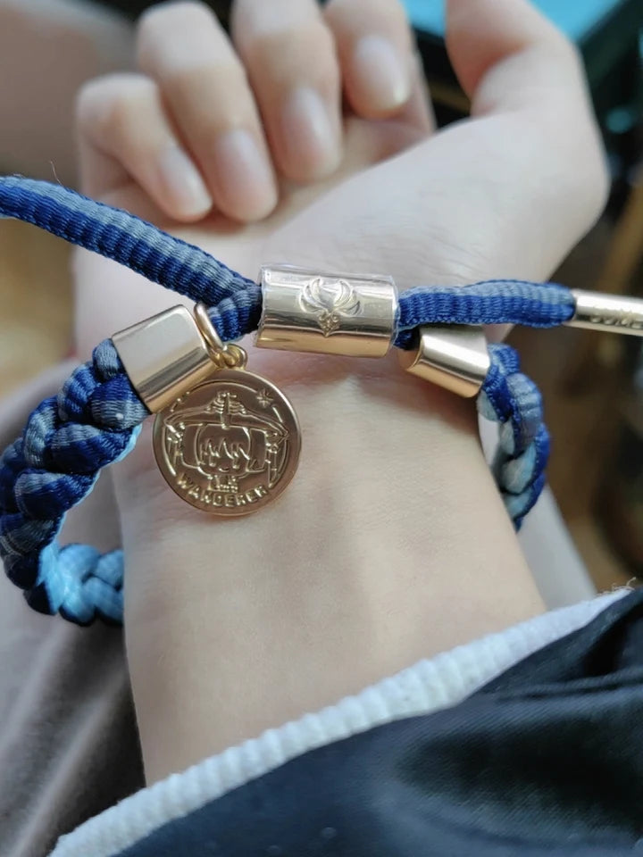 Real customer wearing a dark blue Genshin Impact character-inspired braided bracelet featuring adjustable braided cord and metal charm