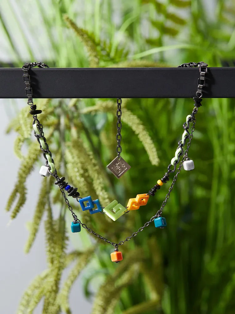 Close-up view of Kinich double layer necklace worn with themed apparel