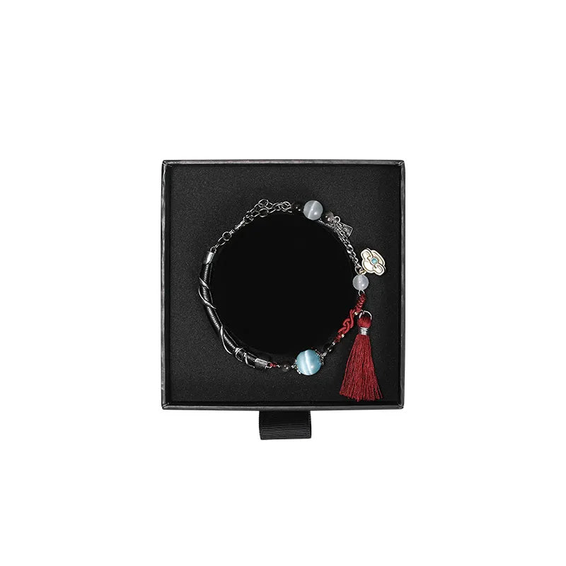 Genshin Impact Shenhe themed bracelet featuring icy blue beads red tassel and elegant accessory details