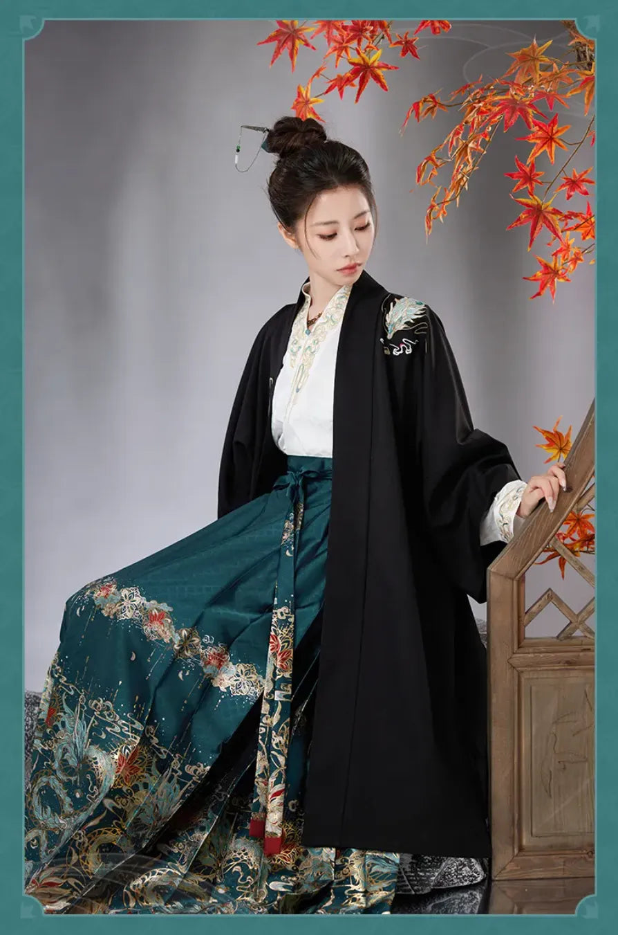 Close-up of Dan Heng Imbibitor Lunae Long Coat featuring lotus and maple leaf embroidery on black fabric