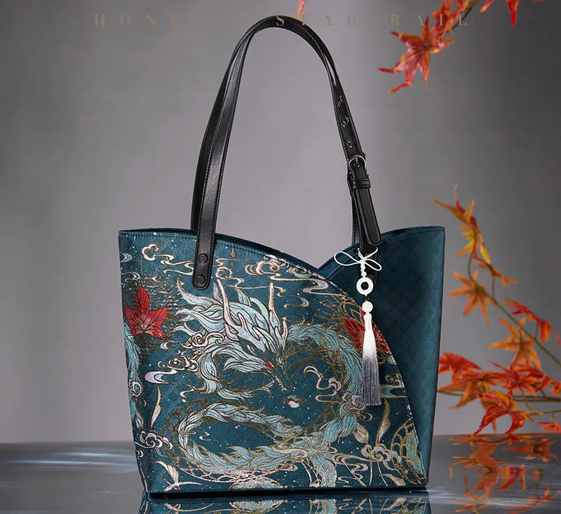 Dan Heng Imbibitor Lunae teal tote bag with decorative tassel charm and detailed dragon artwork