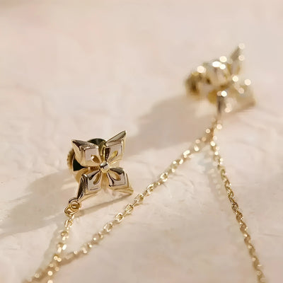 Close-up of Albedo Theme Impression brooch chain detail from Genshin Impact, showing delicate gold-tone chains and star-shaped charm