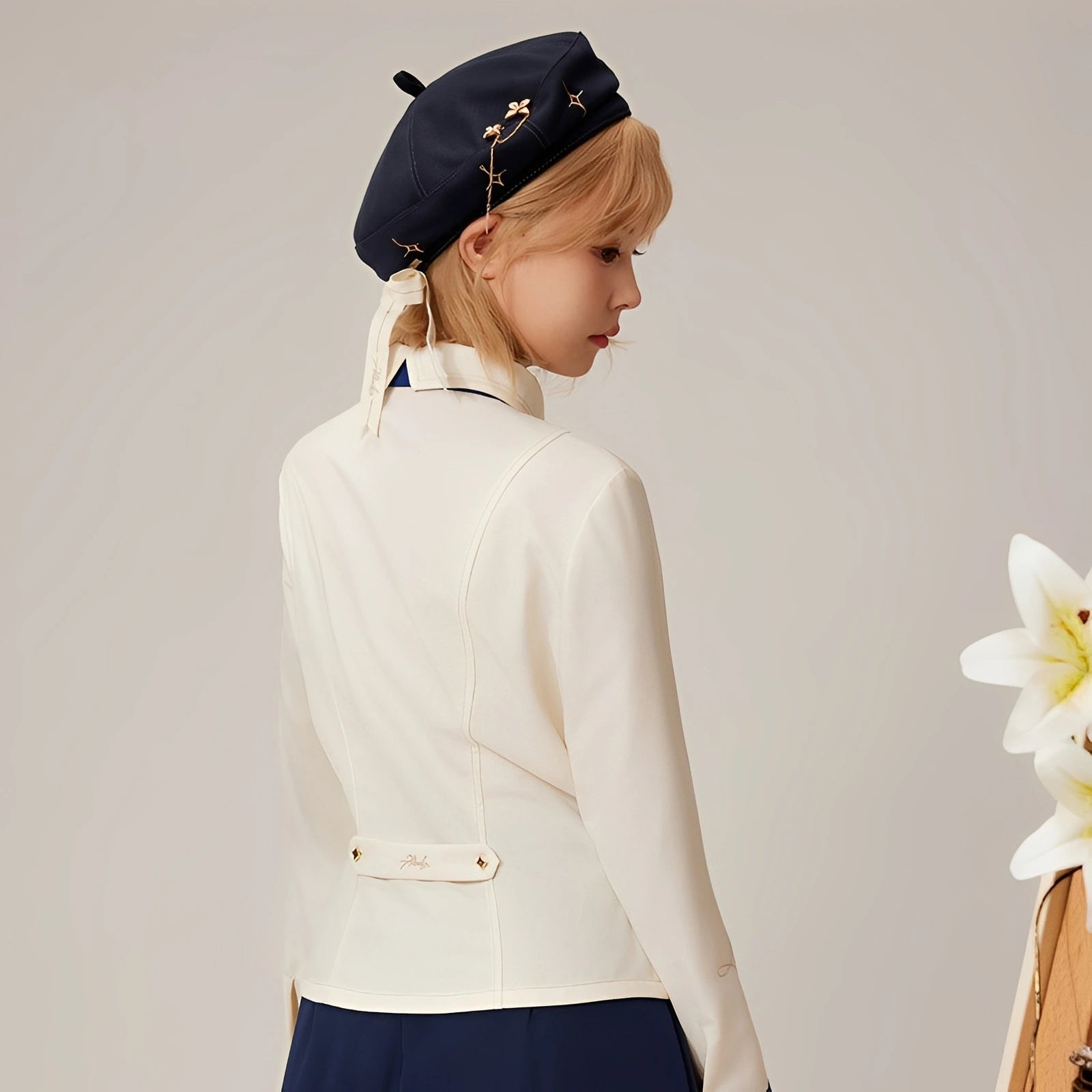 Back view of the Albedo waist-fitted shirt showing tailored silhouette and fitted waist design