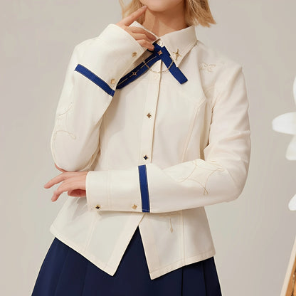 Close-up detail of embroidered shoulder pattern and blue cuff trim on Albedo waist-fitted shirt