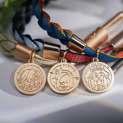 Close-up of metal charms and woven cord details on a Genshin Impact character-inspired braided bracelet