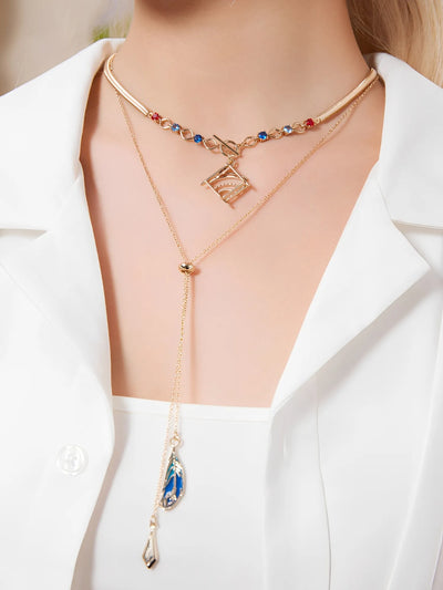 Forest and Sand Series Kaveh jewelry set with layered necklace and asymmetrical earrings worn in outfit