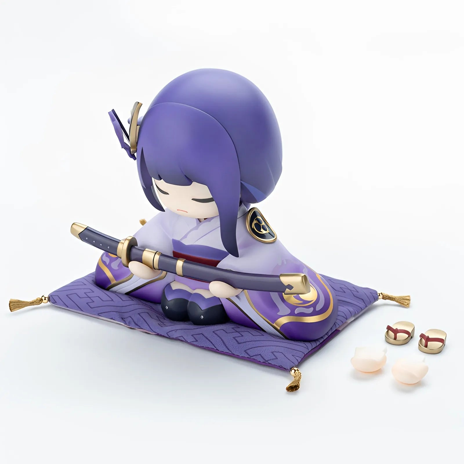 Raiden Shogun chibi statue holding sword in display scene with soft lighting and background
