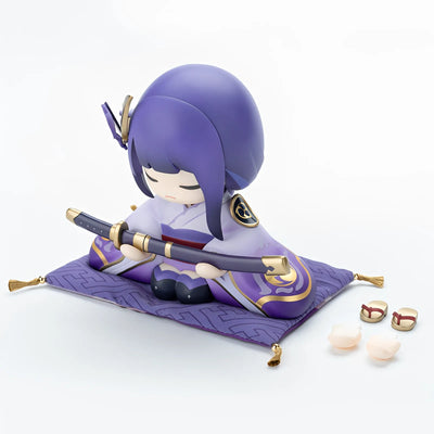 Raiden Shogun chibi statue holding sword in display scene with soft lighting and background