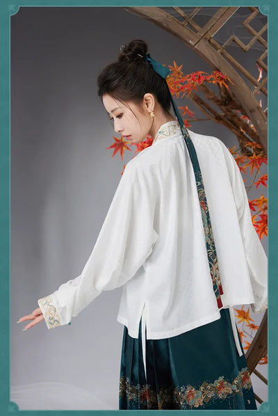 Model wearing black Dan Heng Imbibitor Lunae short jacket with gold embroidered collar and teal Mamian Skirt