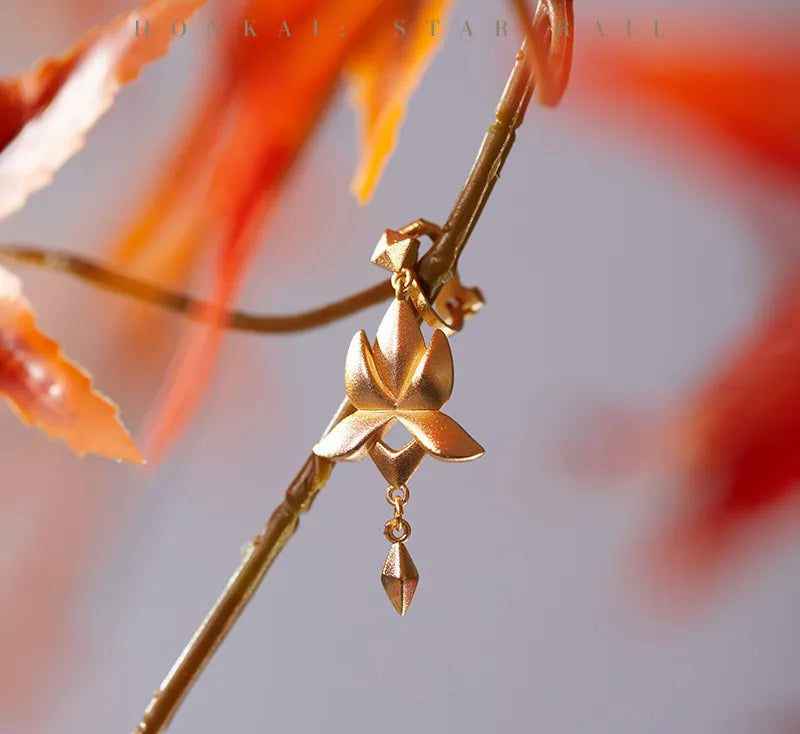 Dan Heng Imbibitor Lunae Water Lotus Ear Cuff styled with black embroidered outfit and autumn foliage
