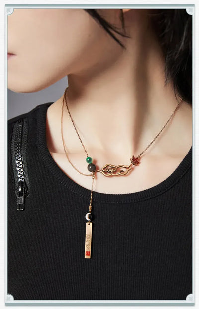 Detailed views of Dan Heng necklace featuring decorative beads and engraved metal pendant