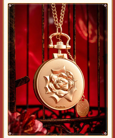 Pocket watch-style metal charm showcasing engraved and plated details