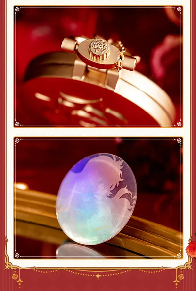 Pocket watch-style metal charm with interchangeable artwork displayed among rose decorations